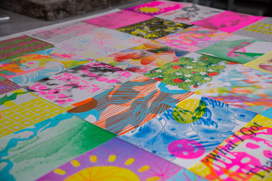 Table covered in colourful Riso prints