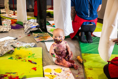 Baby covered in paint at Messy play in DCA Create Space