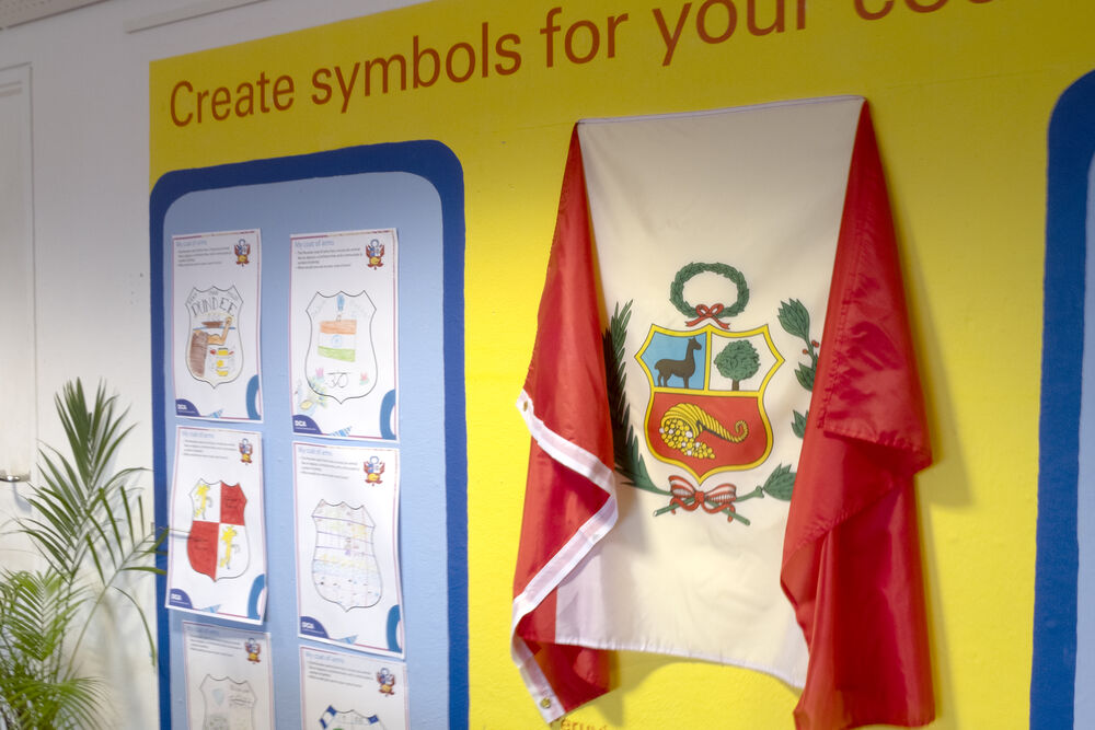 Peruvian flag and completed activit sheets on the wall of Create Space